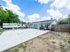 Backyard featuring a large cement pad and grass at 2100 Magnolia Ave, Haines City, FL 33844