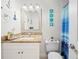 Bathroom with nautical decor, vanity with tan countertop, mirror, toilet and shower at 2100 Magnolia Ave, Haines City, FL 33844
