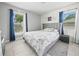 Bedroom with tile flooring, large window, Paris themed comforter, and blue curtains at 2100 Magnolia Ave, Haines City, FL 33844