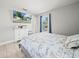 Well-lit bedroom with TV, tile floors, window with blue curtains and Paris themed comforter at 2100 Magnolia Ave, Haines City, FL 33844