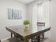Bright dining room with an elegant dark wood table set and lovely natural lighting from the window at 2100 Magnolia Ave, Haines City, FL 33844