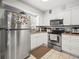 Well-lit kitchen featuring stainless steel appliances, white cabinetry, and neutral countertops at 2100 Magnolia Ave, Haines City, FL 33844