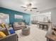 Bright and airy living room showcasing tile flooring, modern furniture, and an open layout into the dining area at 2100 Magnolia Ave, Haines City, FL 33844