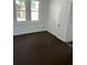 Bedroom with white walls, brown carpet, and natural light from windows at 217 Nw 4Th Ave, Mulberry, FL 33860