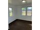 Bedroom with white walls, brown carpet, and natural light from two windows at 217 Nw 4Th Ave, Mulberry, FL 33860