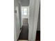 Hallway leading to bedroom, featuring brown carpet at 217 Nw 4Th Ave, Mulberry, FL 33860
