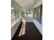 Bright sunroom with floor to ceiling windows and brown carpet at 217 Nw 4Th Ave, Mulberry, FL 33860
