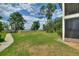 Expansive backyard features a well-maintained lawn and a scenic view of the lake at 2180 San Marcos Se Cir # 401, Winter Haven, FL 33880