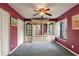 Neutral-toned bedroom with large storage unit and bright red accent wall at 2180 San Marcos Se Cir # 401, Winter Haven, FL 33880