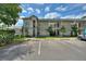 Exterior view of a condominium building with parking and palm trees at 2180 San Marcos Se Cir # 401, Winter Haven, FL 33880