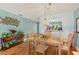 Dining area with hardwood floors and passthrough to kitchen at 2180 San Marcos Se Cir # 401, Winter Haven, FL 33880