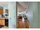 Hallway view with kitchen and living room access and hardwood flooring at 2180 San Marcos Se Cir # 401, Winter Haven, FL 33880