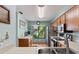 View of the kitchen with window, stainless steel appliances, and wood cabinets at 2180 San Marcos Se Cir # 401, Winter Haven, FL 33880