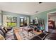 Living room with a view of the outdoors, hardwood flooring and ceiling fan at 2180 San Marcos Se Cir # 401, Winter Haven, FL 33880