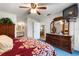 Bright main bedroom leads to main bathroom and boasts large dresser and mounted TV at 2180 San Marcos Se Cir # 401, Winter Haven, FL 33880