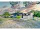 This backyard features a screened-in porch, a shed, and a grassy area at 230 W Harbord St, Lake Alfred, FL 33850