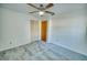 This bedroom features carpet floors, a ceiling fan, and a closet with white louvered doors at 230 W Harbord St, Lake Alfred, FL 33850