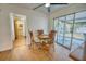 Cozy dining area with wooden table and chairs, laminate flooring, and sliding glass doors at 230 W Harbord St, Lake Alfred, FL 33850