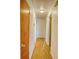 Straight hallway with wood-look laminate flooring, neutral walls, and a simple ceiling light at 230 W Harbord St, Lake Alfred, FL 33850