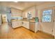 Functional kitchen with white cabinets, granite countertops, and stainless steel dishwasher at 230 W Harbord St, Lake Alfred, FL 33850