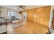 Comfortable living room with wooden paneling and laminate flooring, providing a cozy atmosphere at 230 W Harbord St, Lake Alfred, FL 33850