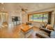 Spacious living room with laminate floors and a large bay window offering natural light at 230 W Harbord St, Lake Alfred, FL 33850