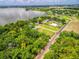 Lakeside homes nestled among mature trees with pools, private driveways, and access to waterfront activities at 250 Brigham Nw Rd, Winter Haven, FL 33881
