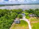 Stunning aerial view showcases the lakefront property with lush greenery and multiple buildings at 250 Brigham Nw Rd, Winter Haven, FL 33881