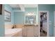 The bathroom features a soaking tub, a vanity with granite counters, and a walk-in closet at 250 Brigham Nw Rd, Winter Haven, FL 33881