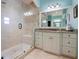 A modern bathroom boasts a frameless shower, granite countertops, and contemporary fixtures at 250 Brigham Nw Rd, Winter Haven, FL 33881