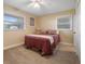 Cozy bedroom featuring neutral walls, carpet, two windows and a ceiling fan at 250 Brigham Nw Rd, Winter Haven, FL 33881
