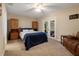 A sunny bedroom features a cozy bed, direct access to the porch, and built-in cabinets at 250 Brigham Nw Rd, Winter Haven, FL 33881