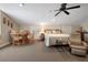 Bright bedroom with a dining table, carpeted flooring, a ceiling fan and comfortable furniture at 250 Brigham Nw Rd, Winter Haven, FL 33881