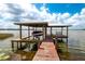 Boat dock on the water, with a boat lift and swing bench at 250 Brigham Nw Rd, Winter Haven, FL 33881