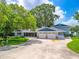 Charming single-Gathering home with lush landscaping, a spacious driveway, and a three-car garage at 250 Brigham Nw Rd, Winter Haven, FL 33881