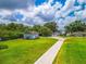 Sprawling property with a long driveway leading to multiple buildings and lush landscaping at 250 Brigham Nw Rd, Winter Haven, FL 33881