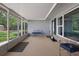 Spacious covered front porch with screening, seating, and a view of the outdoors at 250 Brigham Nw Rd, Winter Haven, FL 33881