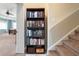 Hallway with stairs and bookcase leading to bedroom, offering functional design and ample storage at 250 Brigham Nw Rd, Winter Haven, FL 33881