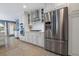 Kitchen boasts a stainless steel refrigerator, range hood, and white cabinets with modern hardware at 250 Brigham Nw Rd, Winter Haven, FL 33881