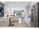 Stylish kitchen with white cabinets, stainless steel appliances, and abundant natural light at 250 Brigham Nw Rd, Winter Haven, FL 33881