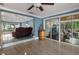 Spacious living room with tile flooring, barrel accent table, and sliding glass doors to the outside at 250 Brigham Nw Rd, Winter Haven, FL 33881