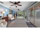 Bright and airy living room with tile floors, ceiling fans, and seamless indoor/outdoor flow at 250 Brigham Nw Rd, Winter Haven, FL 33881