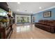 Open living area with large windows and a comfortable leather sofa at 250 Brigham Nw Rd, Winter Haven, FL 33881