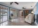 Inviting living room with tile floors, a ceiling fan, and views of the pool area at 250 Brigham Nw Rd, Winter Haven, FL 33881