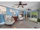 Open concept living room features tile floors, ceiling fans, and glass doors leading to a screened porch at 250 Brigham Nw Rd, Winter Haven, FL 33881