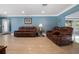 The open living room showcases tile flooring, leather furniture, and natural light at 250 Brigham Nw Rd, Winter Haven, FL 33881