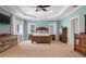 A bright, spacious main bedroom is furnished with wood furniture and bathed in natural light from several windows at 250 Brigham Nw Rd, Winter Haven, FL 33881