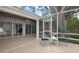 Relaxing screened-in patio with seating area and views of the lush backyard at 250 Brigham Nw Rd, Winter Haven, FL 33881