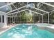 Inviting screened-in pool with attached spa, mature landscaping, and ample deck space perfect for entertaining at 250 Brigham Nw Rd, Winter Haven, FL 33881