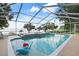 Stunning pool area with a spa, lake views, and a screened enclosure at 250 Brigham Nw Rd, Winter Haven, FL 33881